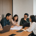 Rapat tim organisasi non-profit membahas dokumen pengajuan fasilitas kepabeanan